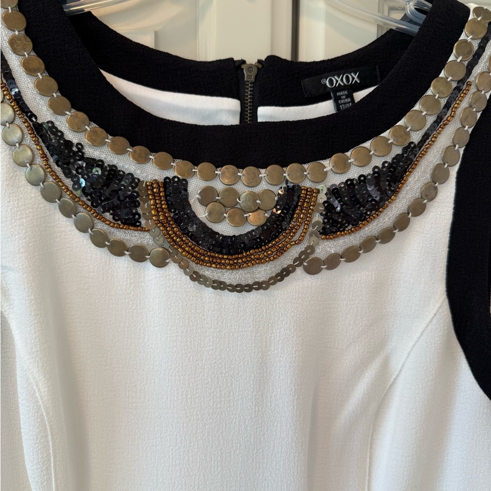 NWOT. Off-white OXOX Dress with Black trim
and Metal Embellishment. Size 13-14